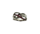Silver ring with embedded red gemstones on a white background