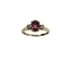 Gold ring with a pink gemstone and smaller diamonds on a white background