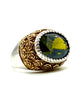 .925 Sterling Silver Two-Tone Textured Bezel Green Stone Ornate Statement Ring Ring with gold and silver design and a central gemstone on a white background