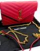 Red handbag with gold chain on a black Saint Laurent bag