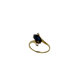 Gold ring with a blue gemstone on a white background