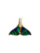 A gold pendant shaped like a whale tail, featuring vibrant green and blue iridescent opal inlay and a vertical row of small clear stones at the top, shown on a plain white background.