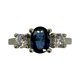 14K White Gold 1/3CTW Diamond Oval Sapphire Bridge Ring Ring with a central blue gemstone flanked by two diamonds on a white background