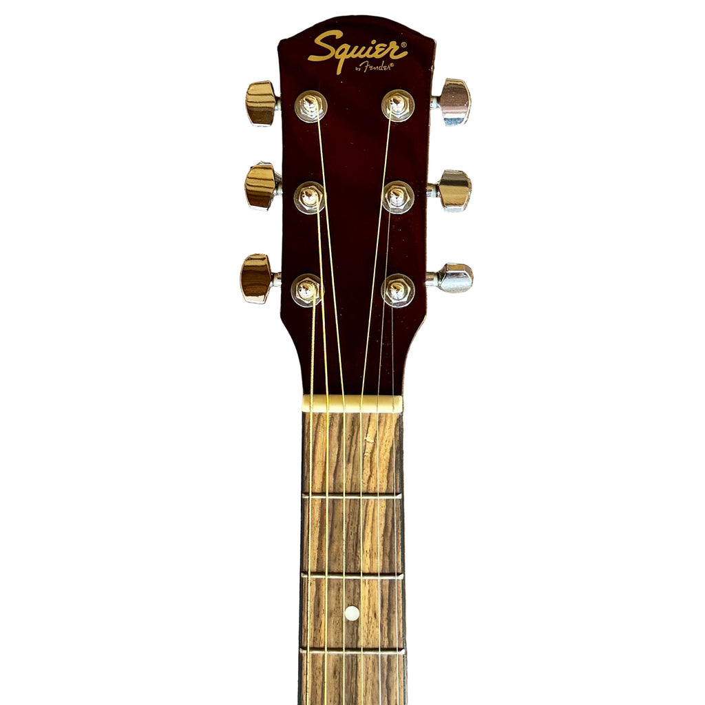 Fender Squier 093-0315-021 Acoustic Guitar headstock with 'Squier' branding on a wooden surface