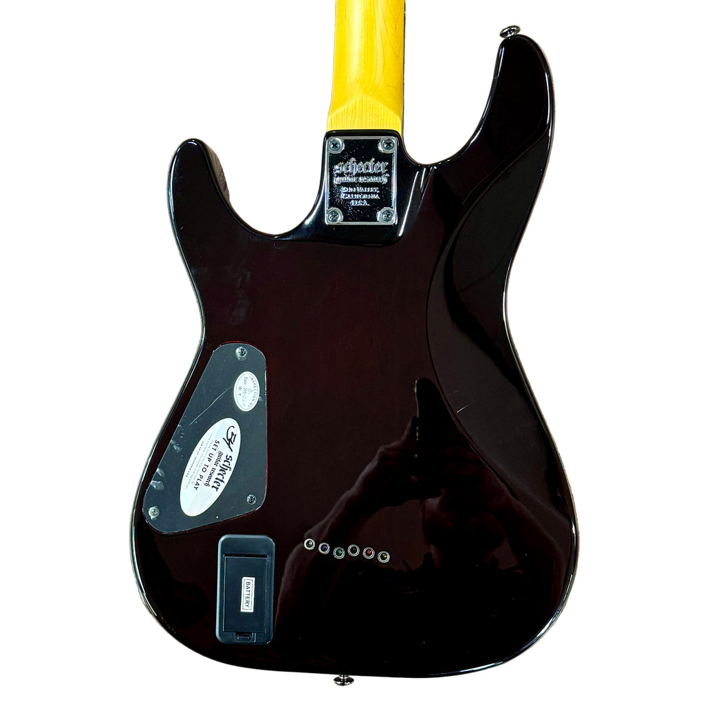 Schecter Diamond Series DEMON-6 Electric Guitar Black electric guitar with yellow pickguard on a wooden floor