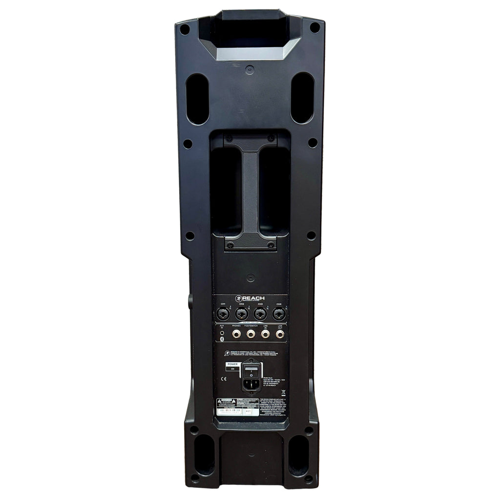MACKIE REACH 750W Professional PA Speaker System w/ Carrying Case Black speaker on a wooden floor with a textured wall background