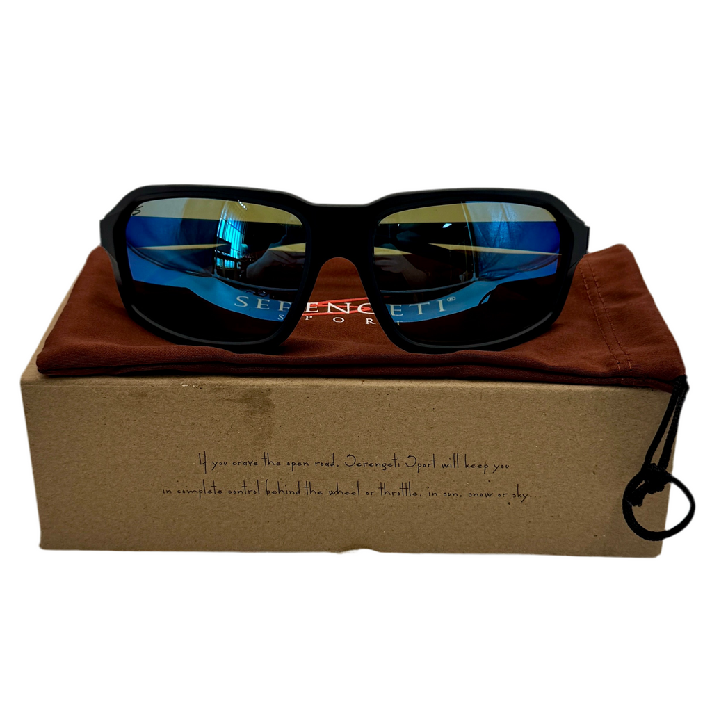 Serengeti Sport HEXT Saturn Polarized Sunglasses - Matte Black Frame w/ Blue Lenses (SS571003) Sunglasses with blue reflective lenses on a brown cushion inside a branded box.