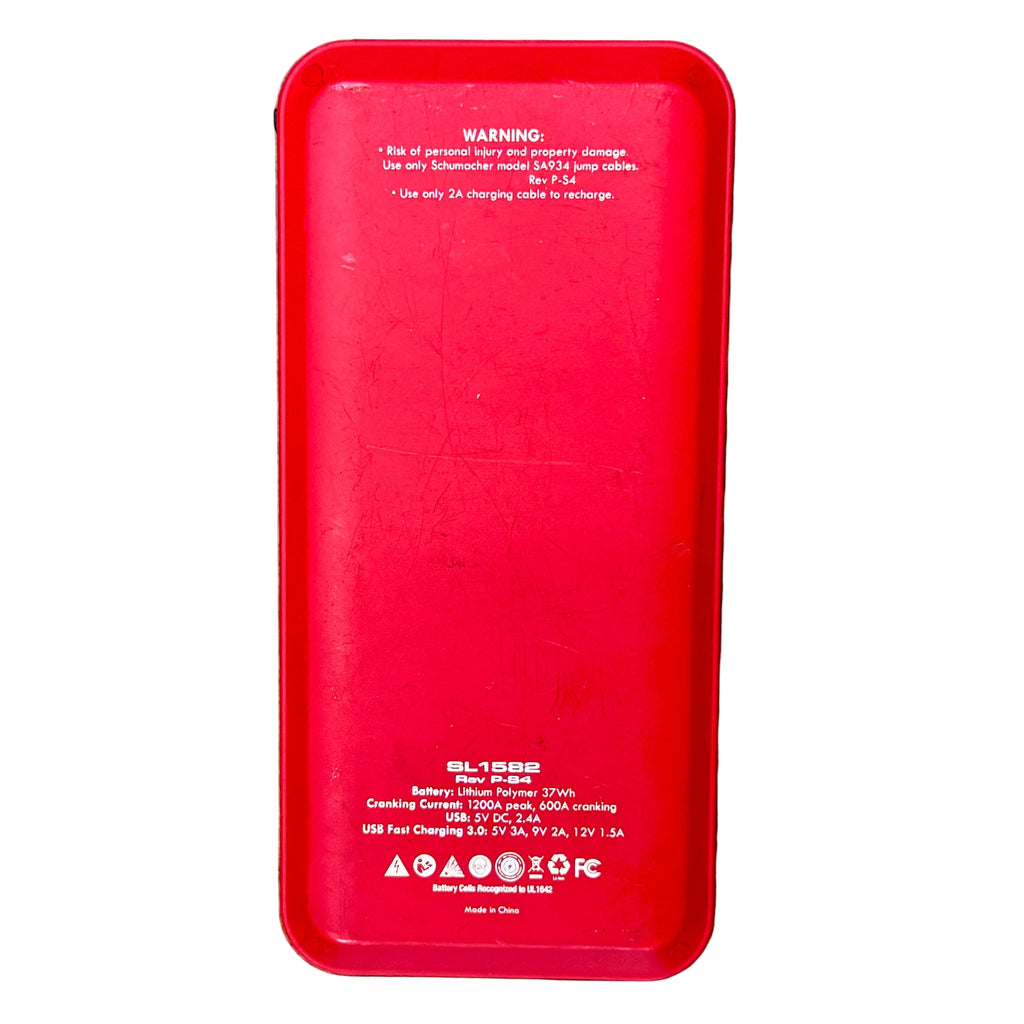 Schumacher Electric 1200A 12V Lithium Jump Starter & Power Pack (SL1582) Red power bank with warning labels on a wooden surface