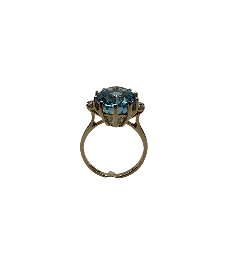 Ring with a blue gemstone on a white background