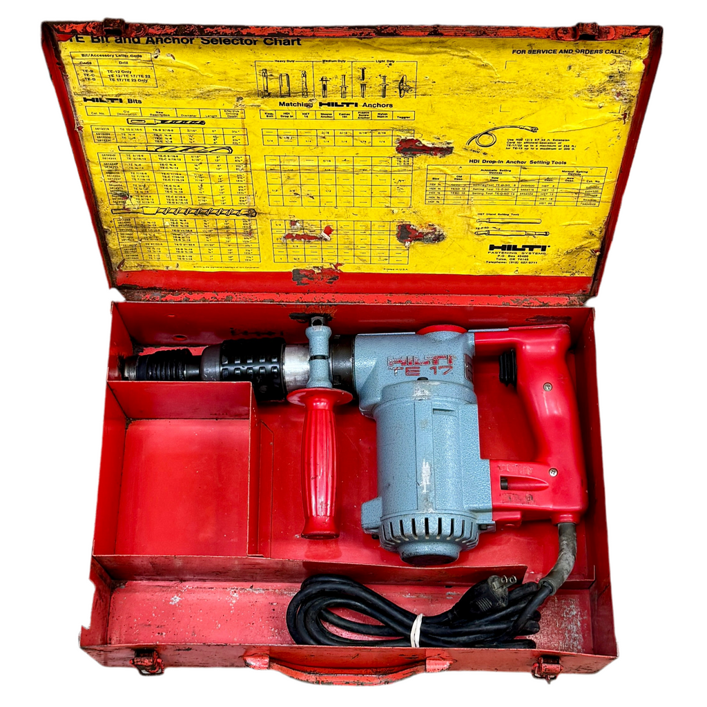 Red and gray drill in a red toolbox with yellow lid featuring text and diagrams.