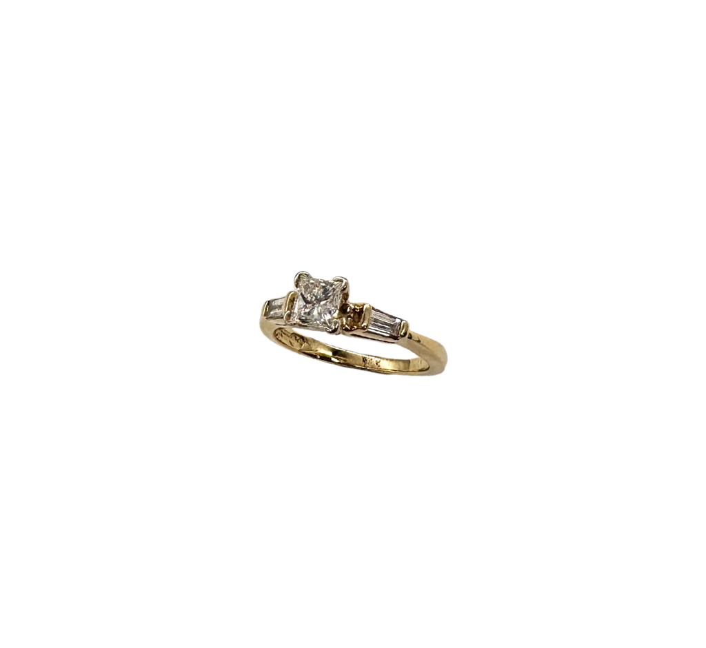 Gold ring with diamond on a white background