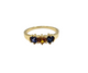 Gold ring with three gemstones on a white background
