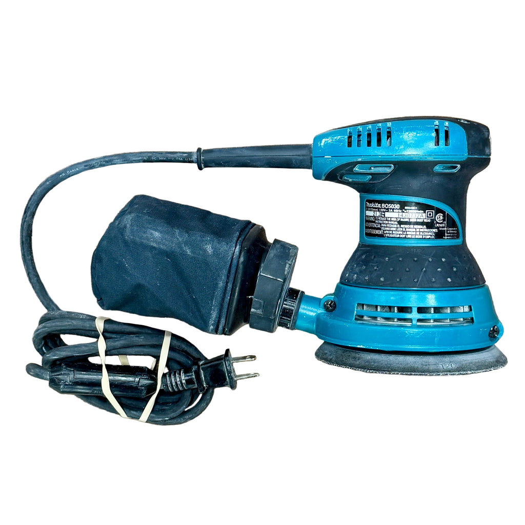 Makita 3-Amp 5" Corded Random Orbital Sander w/ Hard Case (BO5030) Blue sanding machine with power cord on a wooden surface