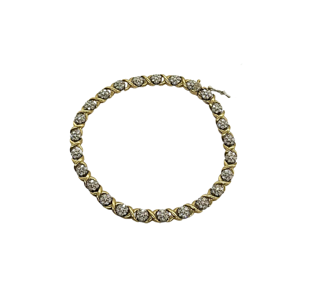 Gold bracelet with clear stones on a white background