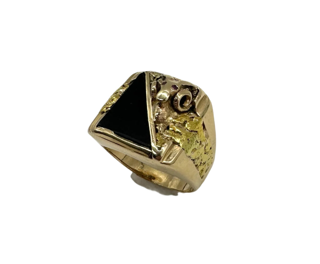 Gold ring with a black gemstone on a white background