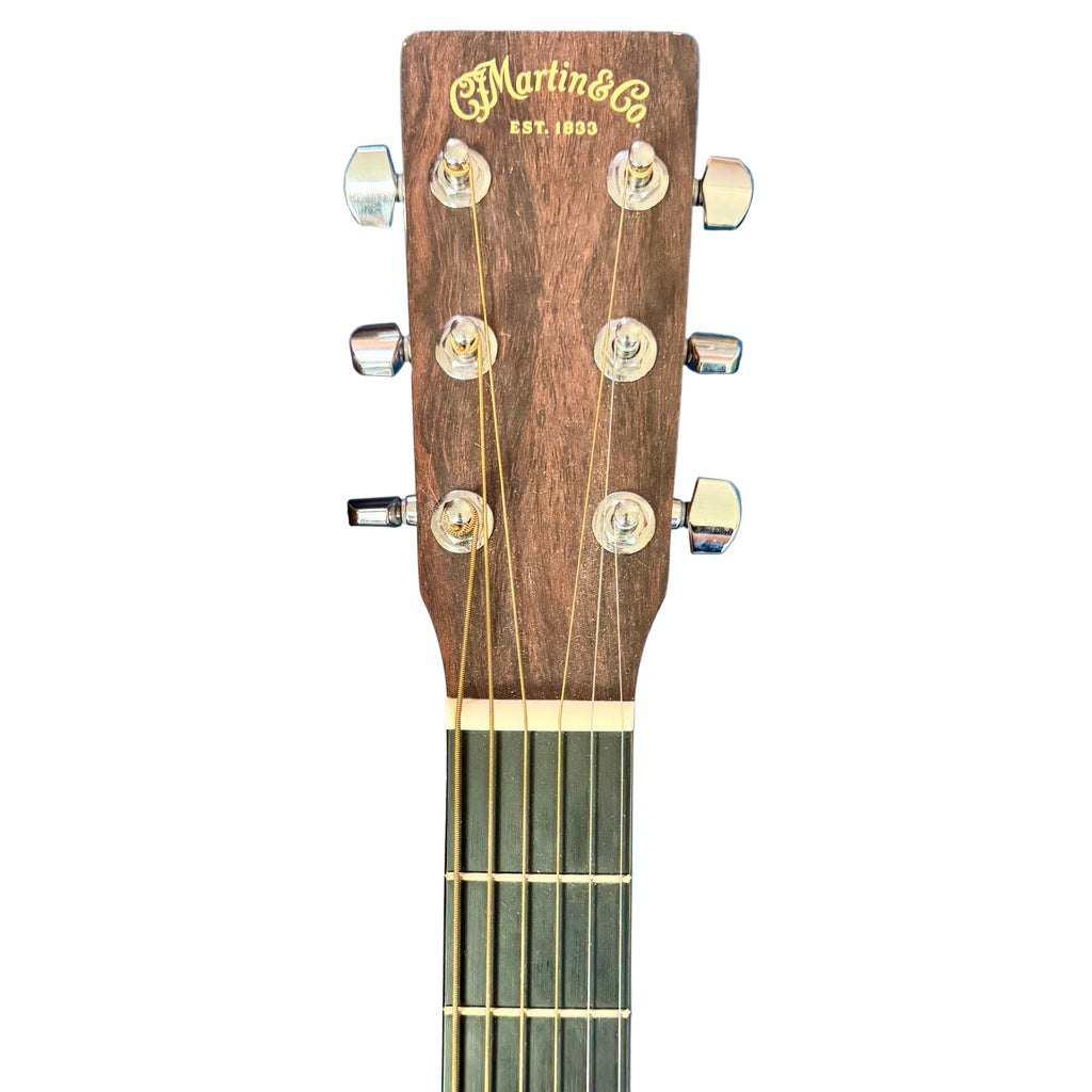 Martin X Series Special Acoustic-Electric Guitar w/ Soft Case Guitar headstock with 'Martin & Co' branding on a blue surface