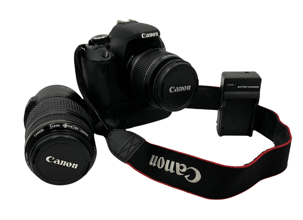 Canon camera with lens and battery pack on a white background