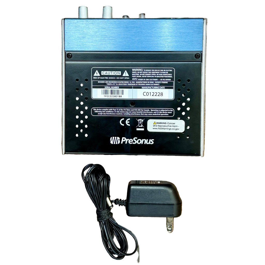 PreSonus TUBEPre V2 Tube Microphone Preamp PreSonus audio device with power adapter on a wooden surface