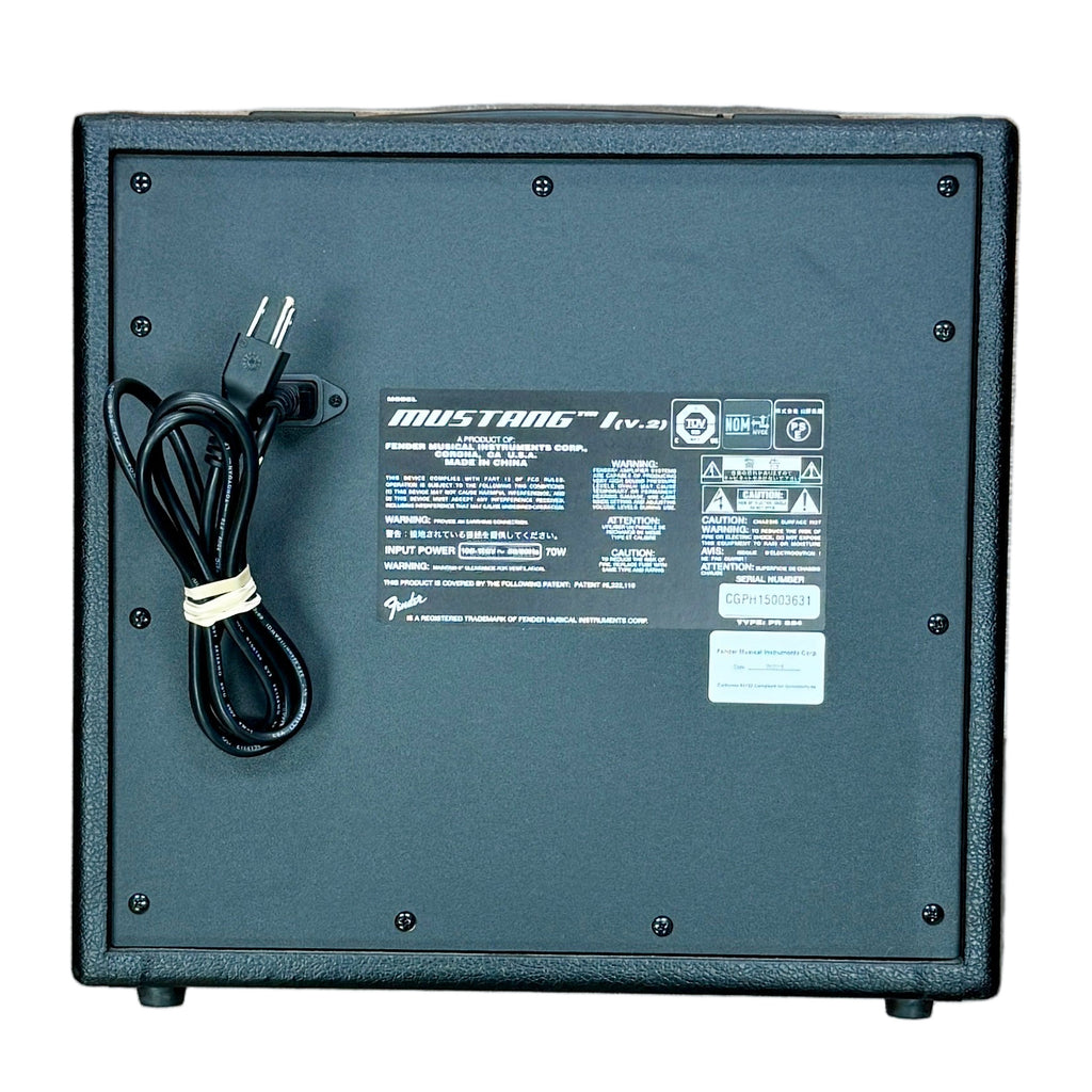 Fender MUSTANG I V2 Guitar Combo Amplifier Black electronic device with a power cord on a wooden floor