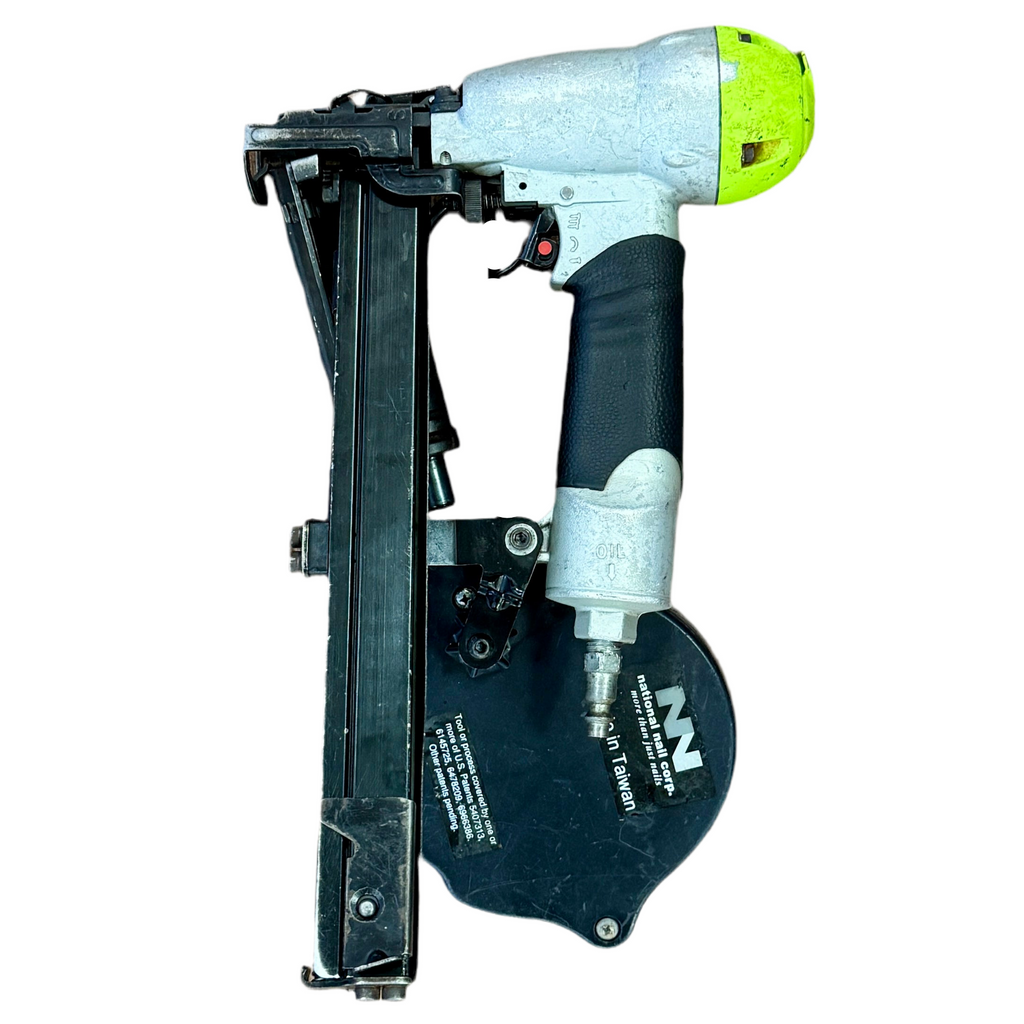 Nail gun with green trigger on a white background