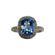 10K White Gold Cushion Cut Blue Mystic Topaz Diamond Halo Ring Ring with a blue gemstone and diamond accents on a white background