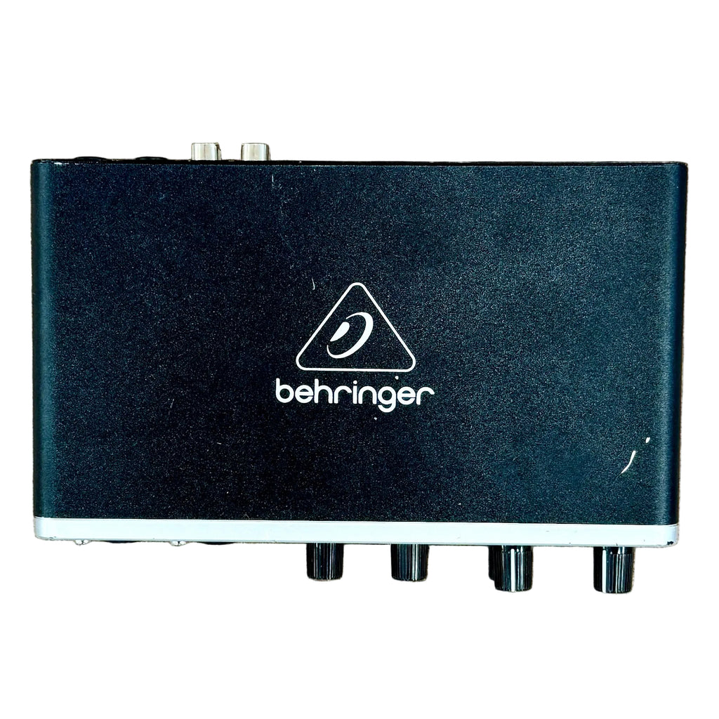 Behringer U-PHORIA UMC204HD USB Audio Interface Black electronic device with Behringer logo on a wooden surface