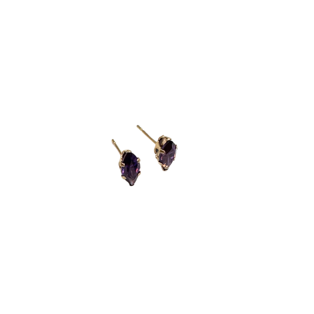 Gold earrings with purple gemstones on a white background