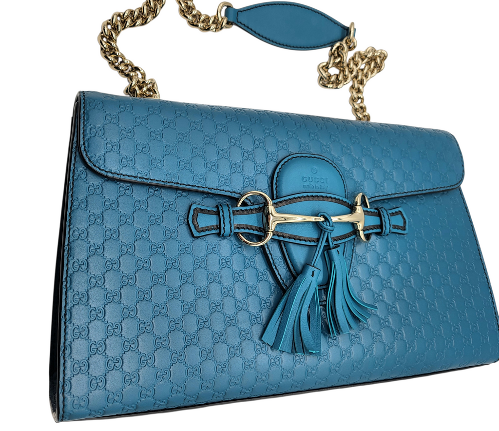 Blue handbag with a chain strap on a white background
