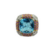 Jewelry with a blue gemstone surrounded by smaller colored stones on a white background