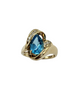Gold ring with a blue gemstone on a white background