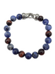 Beaded bracelet with blue and brown beads and a silver clasp on a white background
