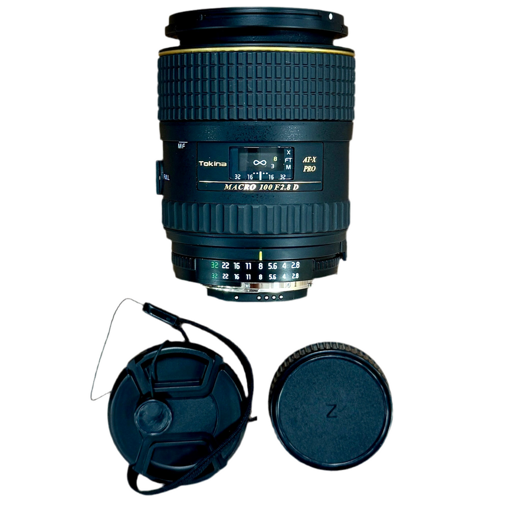 Tokina AT-X PRO MACRO 100mm f/2.8D Camera Lens w/ Front & Rear Caps (Canon EF/Nikon F) Camera lens with lens cap and hood on a white background