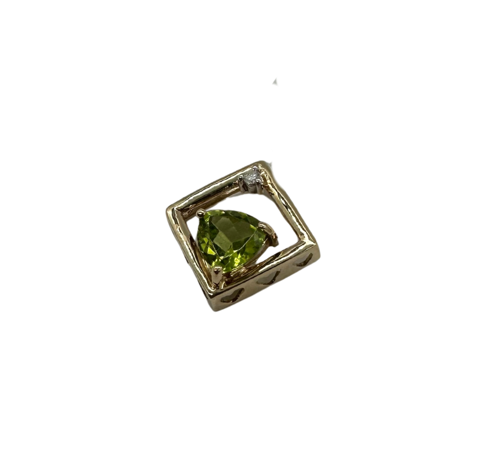 Gold pendant with a green gemstone on a white background