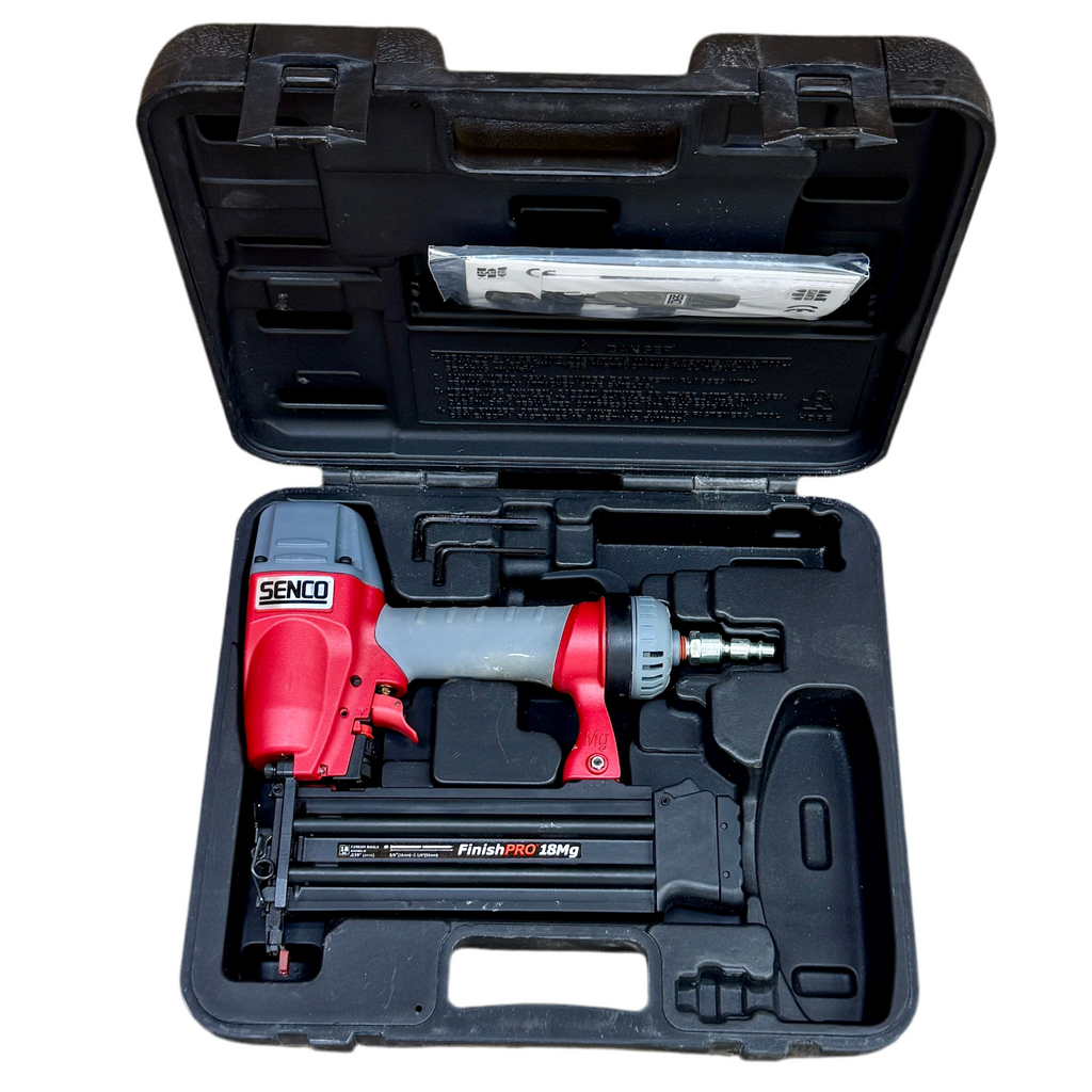 Red and gray nail gun in a black carrying case on a white background