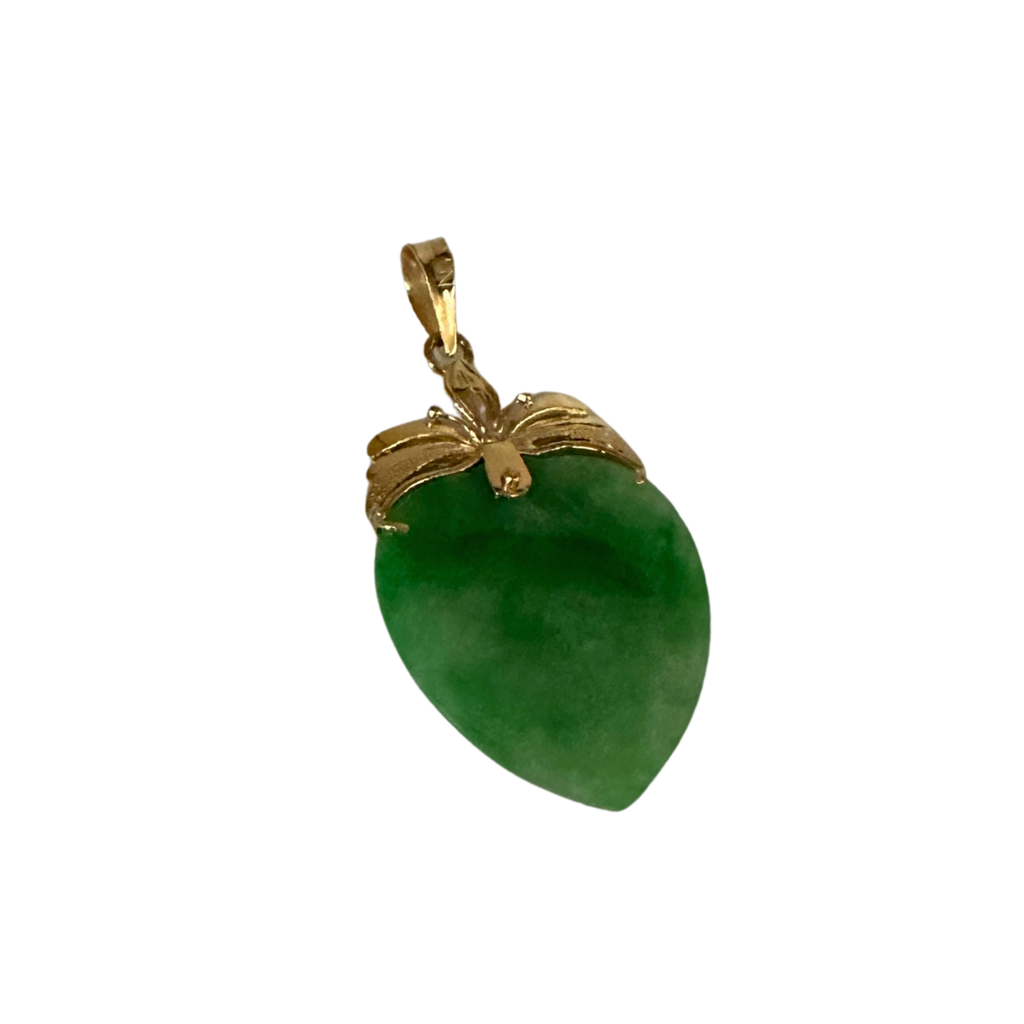 Green jade pendant with gold setting on a white background