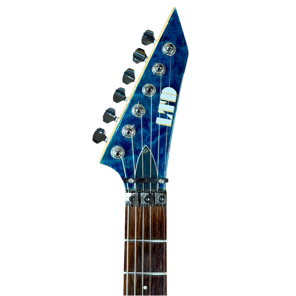 ESP LTD MH-100QM Electric Guitar Close-up of a guitar headstock with blue and brown design on a white background