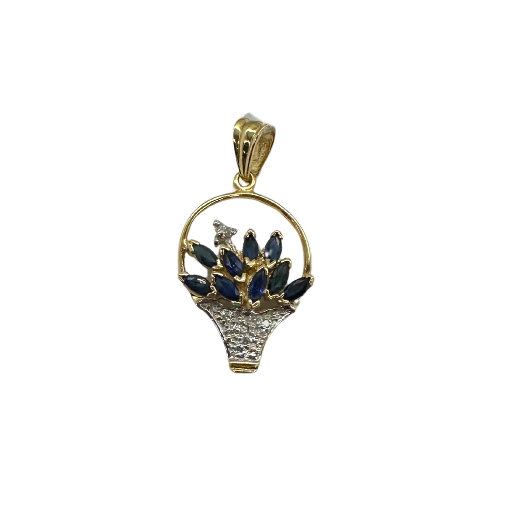 Gold pendant with blue gemstones on a white background