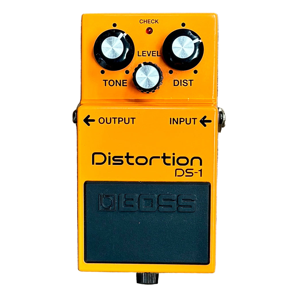 BOSS DS-1 Distortion Guitar Effects Pedal Boss DS-1 distortion pedal with three knobs on an orange background