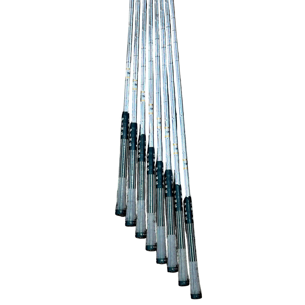 PING ZING Red Dot 8-Piece Iron Set RH Golf Clubs (3-7, 9, W, S) Set of fishing rods on a wooden floor