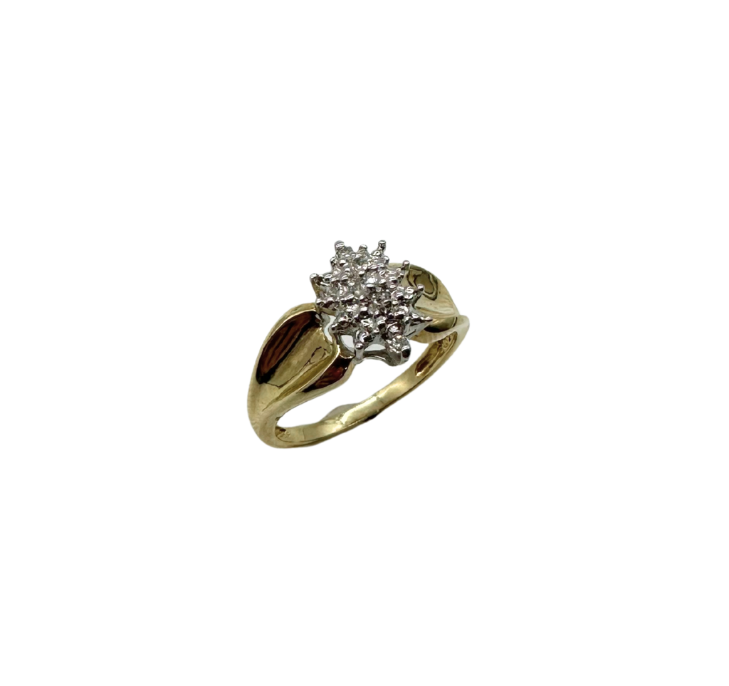 Gold ring with a diamond cluster on a white background