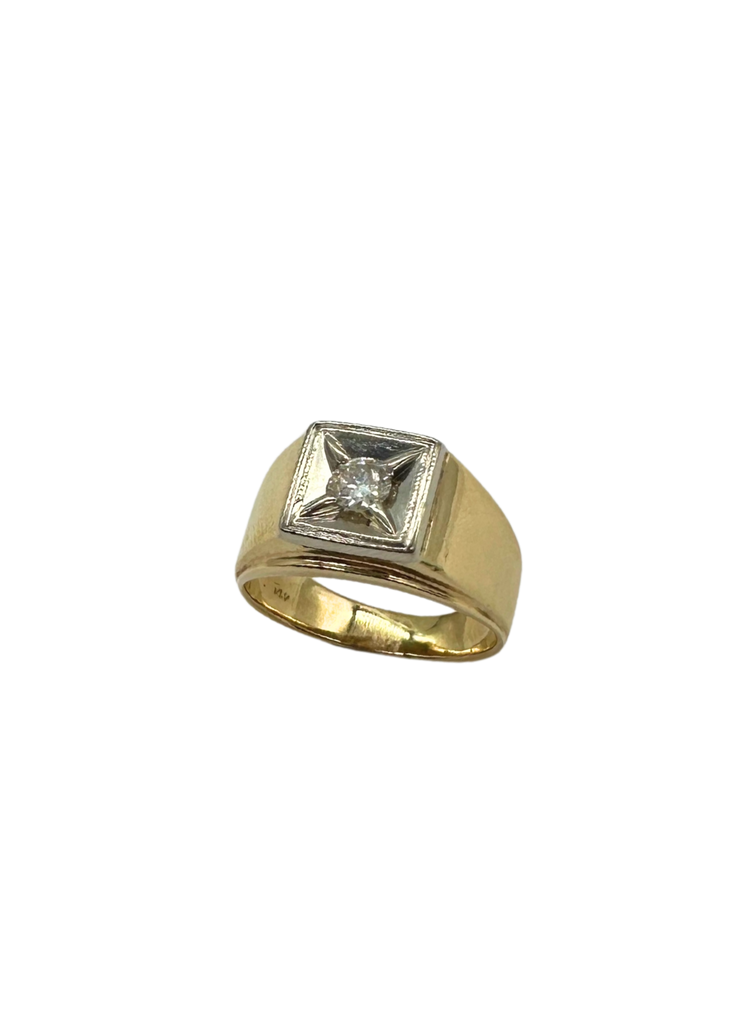 Gold ring with a diamond on a white background