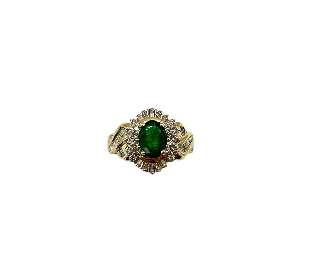 Gold ring with a green gemstone on a white background