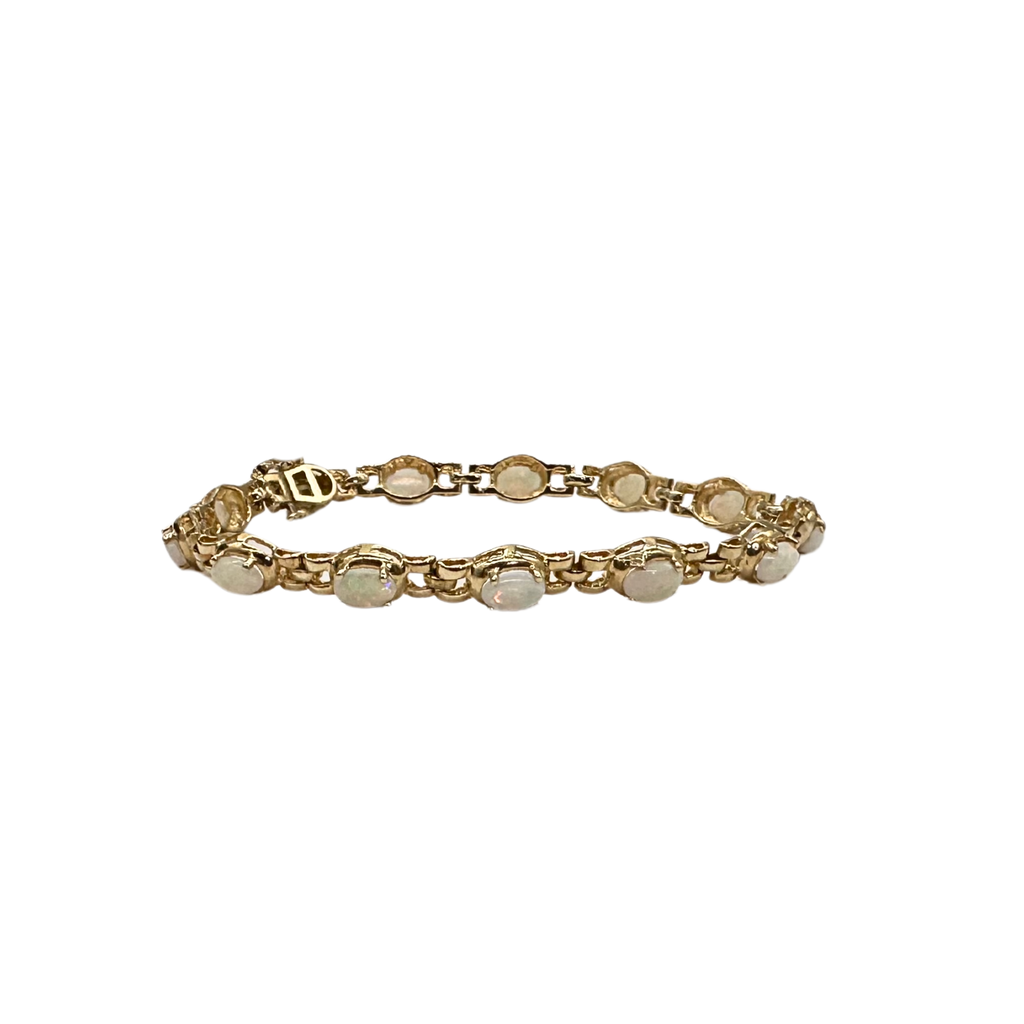 Gold bracelet with circular links on a white background