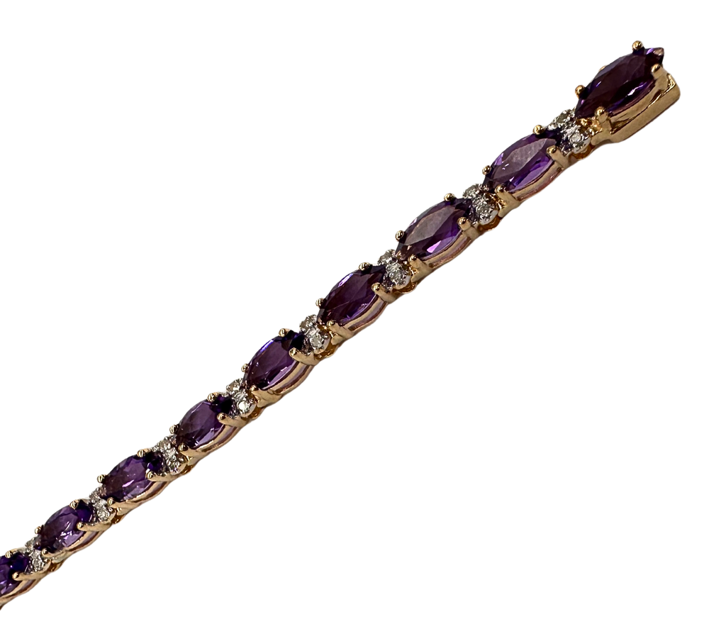 Gold bracelet with purple gemstones on a white background