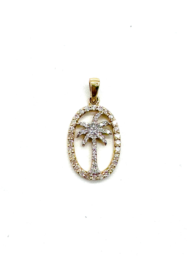 Gold pendant with palm tree design on a white background