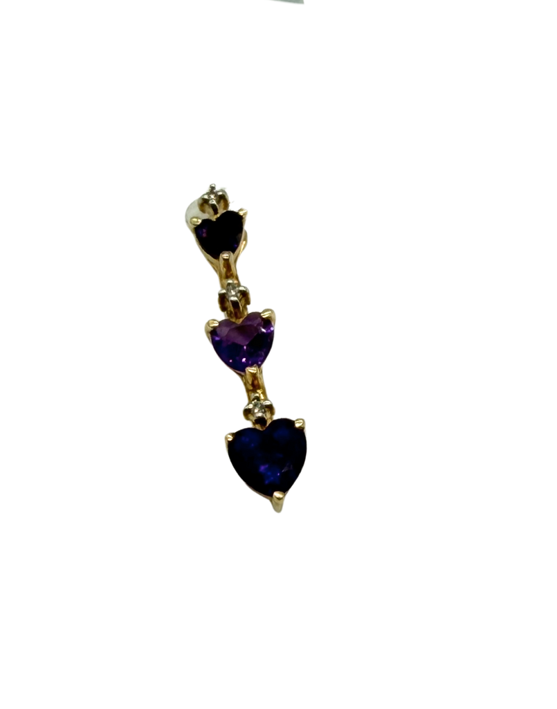 Gold pendant with heart-shaped gemstones on a white background