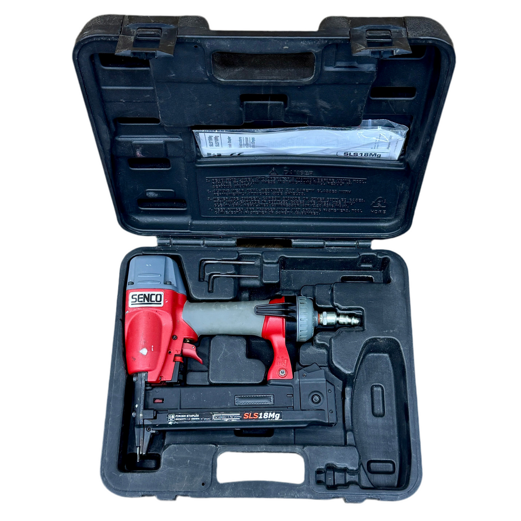 Red and black nail gun in an open black case on a white background