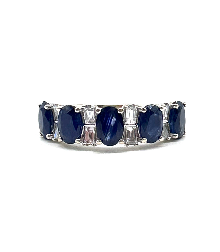 Silver ring with blue gemstones on a white background