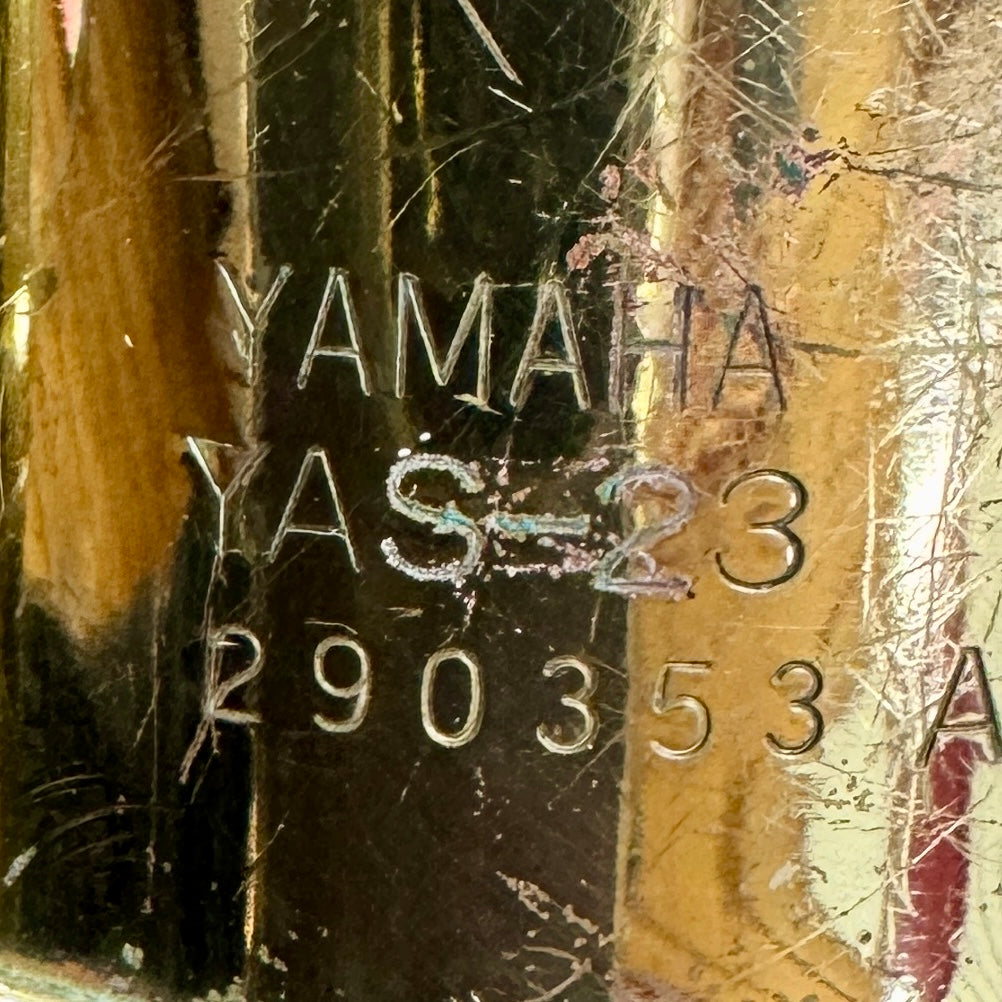 Yamaha YAS-23 Alto Saxophone w/ Hard Case (Serial # 290353 A) Yamaha product with model number YAS-23 and serial number on a reflective surface.