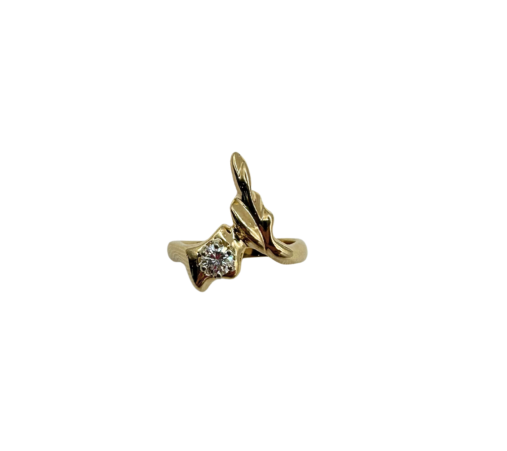 Gold pendant with a diamond on a white background
